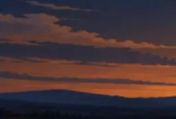 Scarecrow Field banner with orange twilight above dark distant hills.